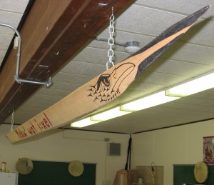 Our model of a racing canoe that hangs in one of our clasrooms.  Designed by local Chehalis artist, Rocky Larock, it reads "Mekw' wat i:xel" which is Halq'emeylem for "pulling together" - a motto at our school.